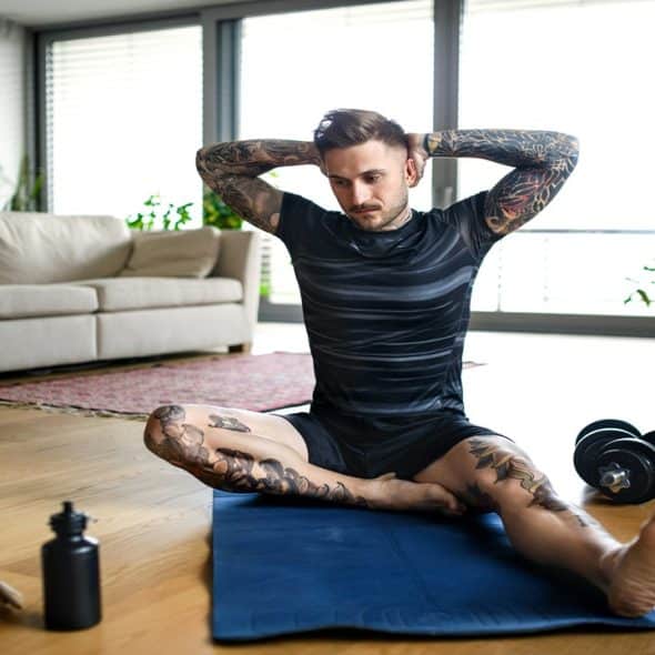 A man stretches as he prepares for exercise.