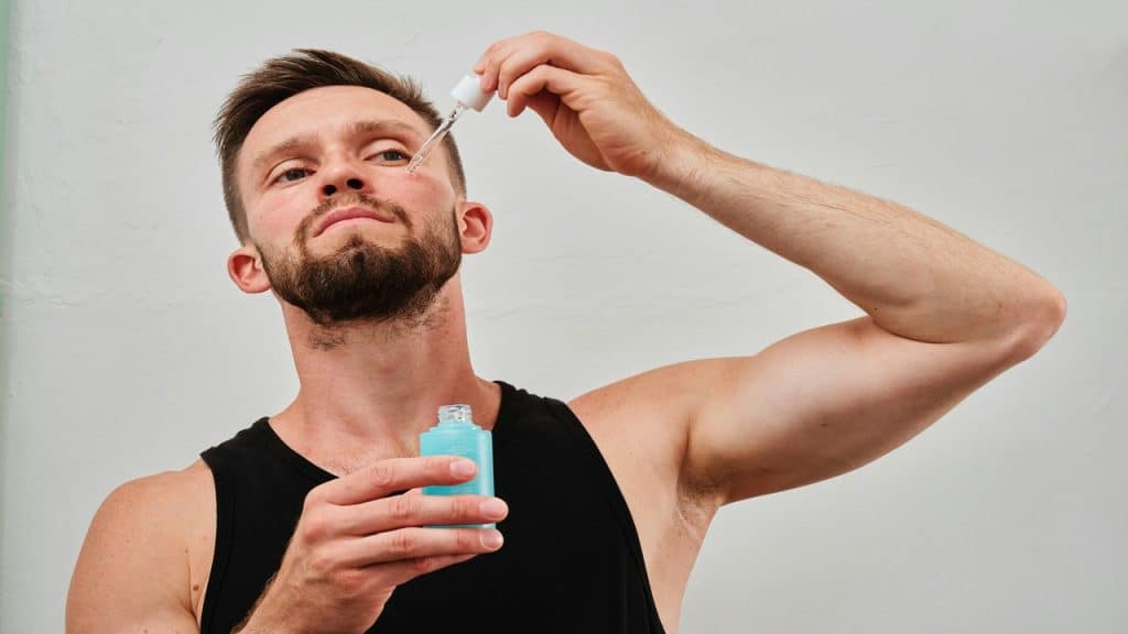 A man puts salicylic acid on his face.