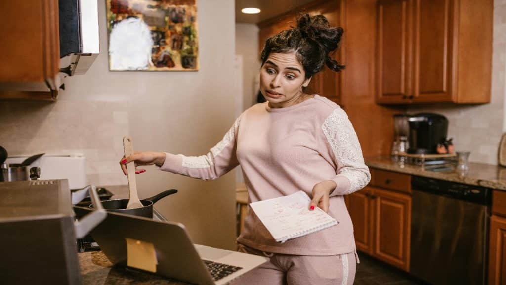 A woman manages household responsibilities alone while her partner remains unaware and uninvolved.