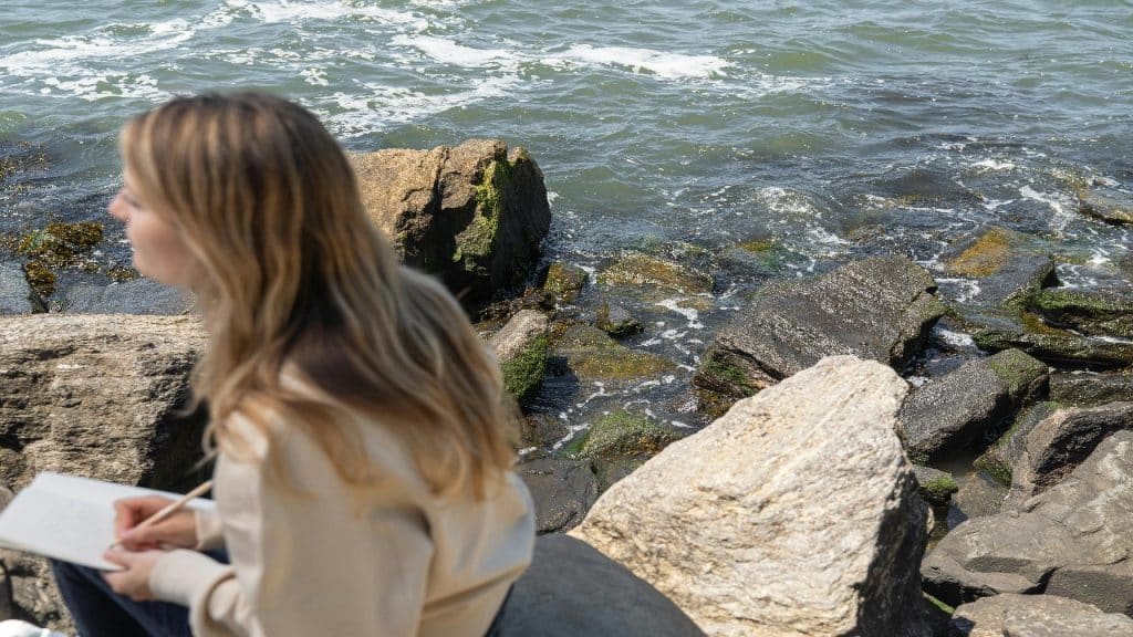 A woman pauses for self-reflection in a quiet space, showing emotional awareness.
