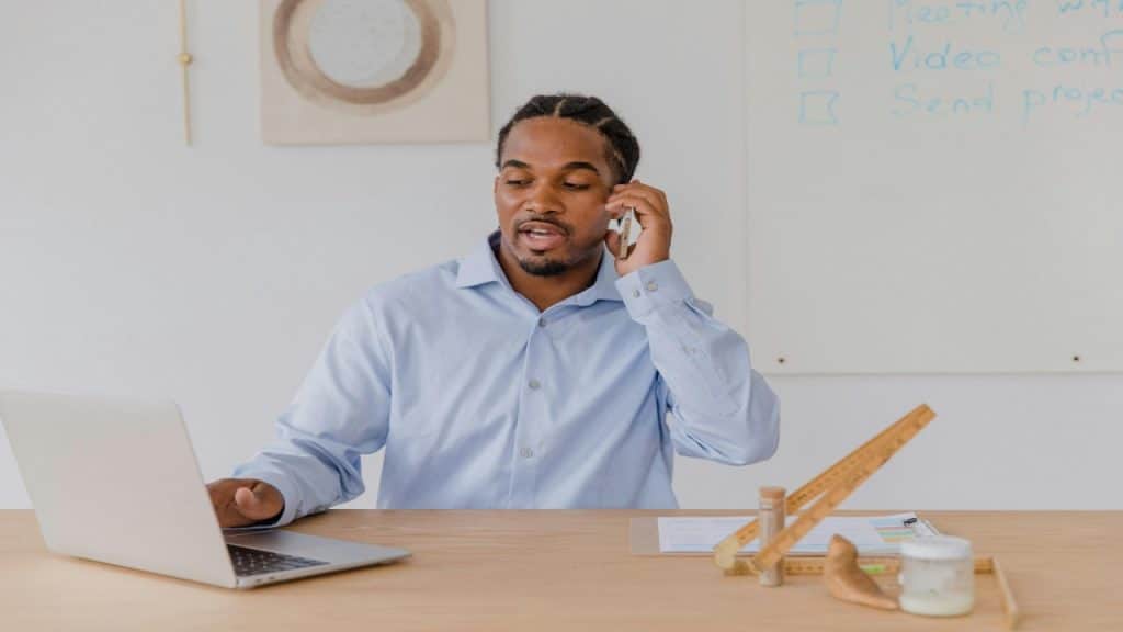 A man having a call setting plans with clarity, and managing social expectations proactively.