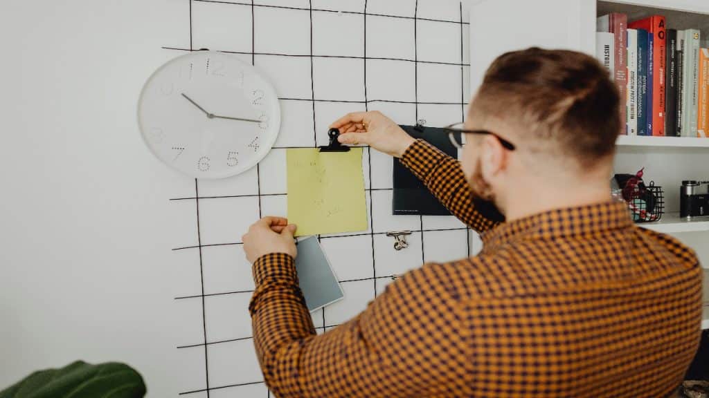 A man re evaluating his boundaries by checking his time and energy intentionally.