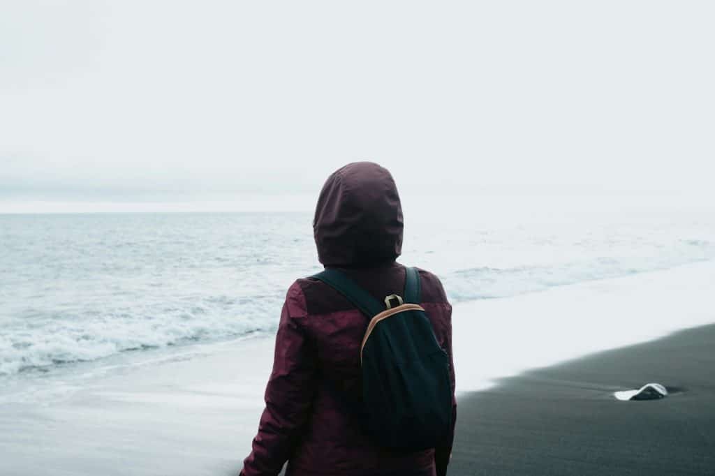 A person walking at the beach alone