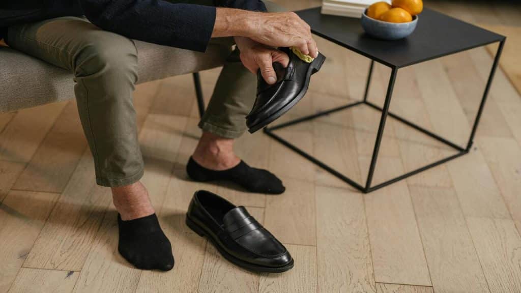 A man cleaning his leather shoes.