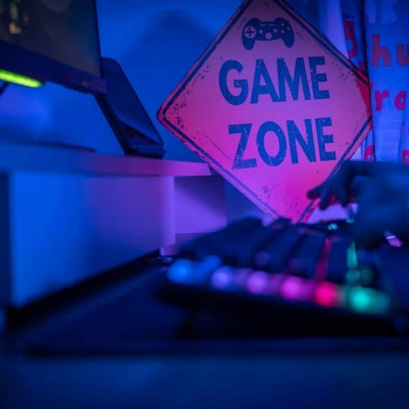A gaming zone sign beside the computer.