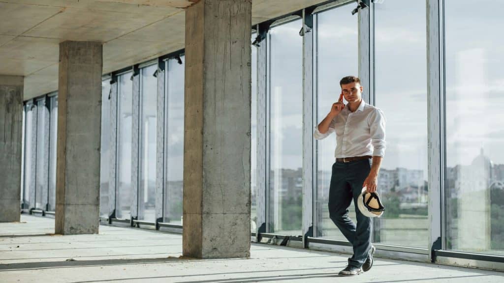 A man wearing button-up shirt and trousers.