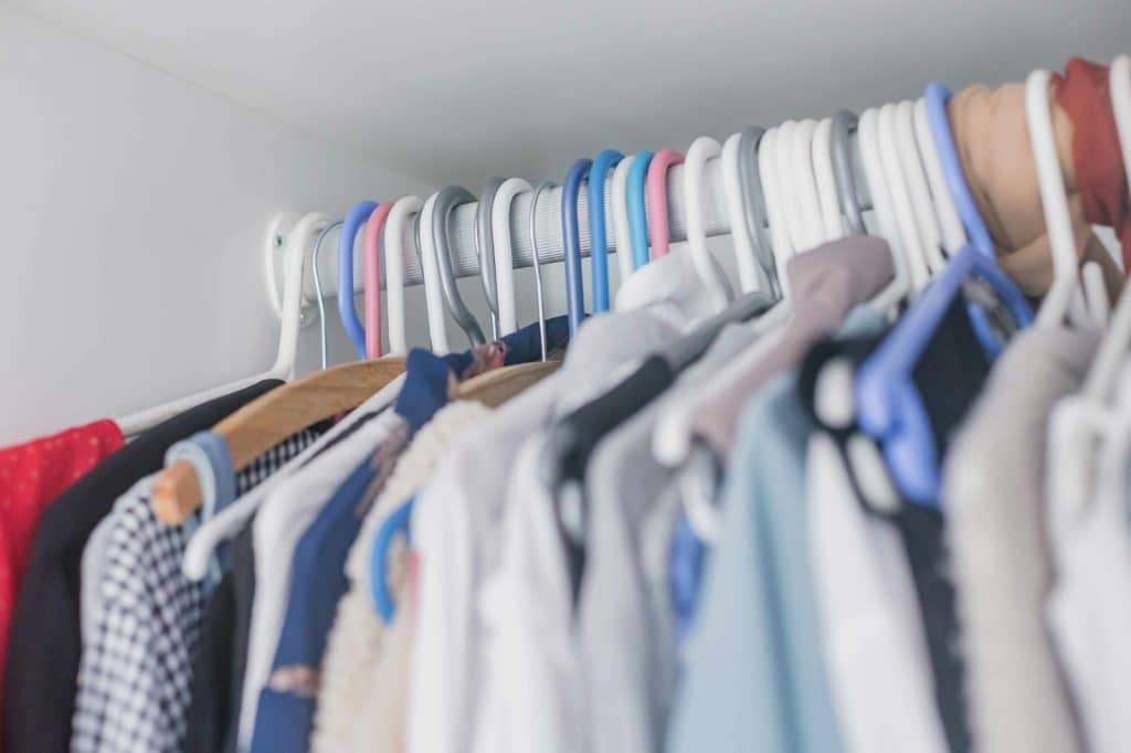 Clothes hanging on a rack.