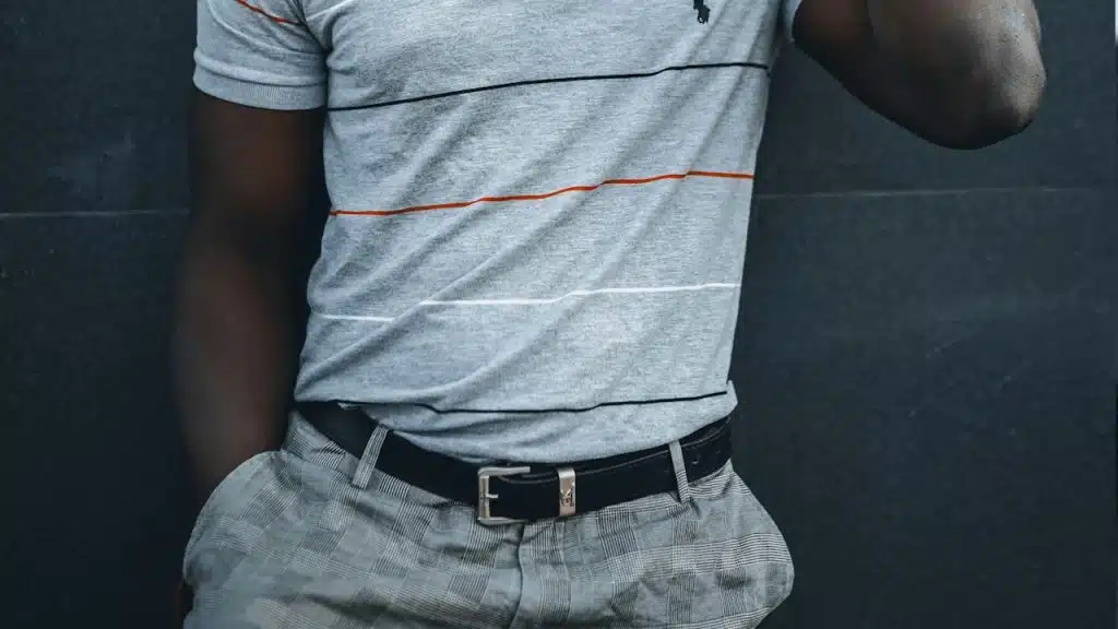 man wearing a polo shirt tucked into his pants.