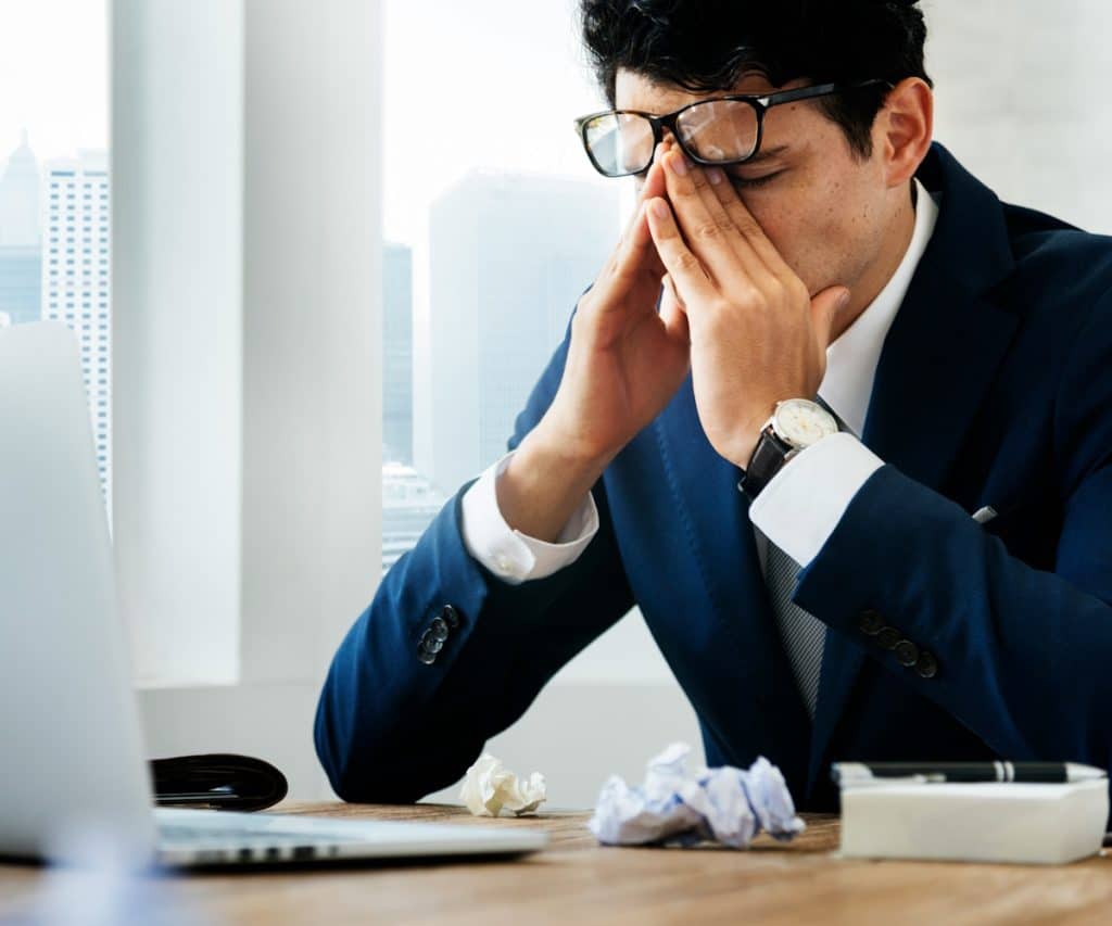 A man looking frustrated at work.