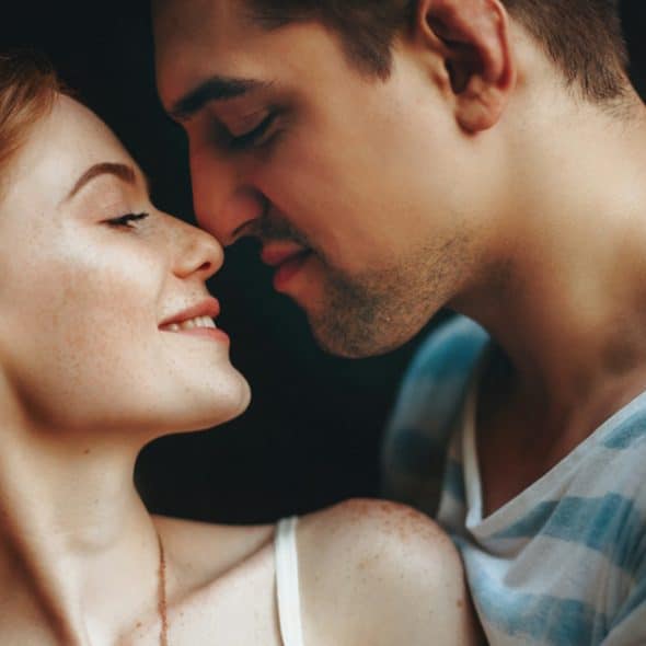 A man and woman facing each other.