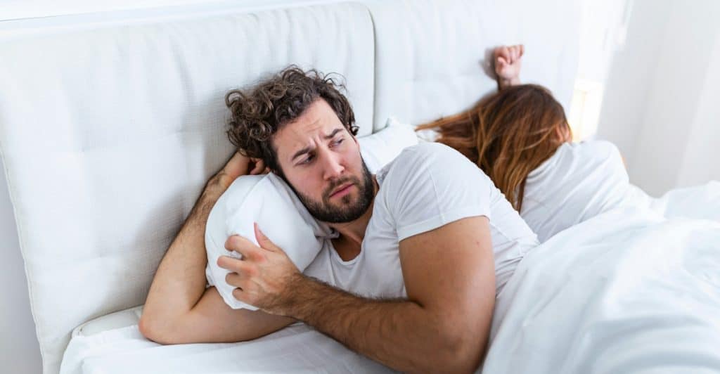 A couple not talking in bed.