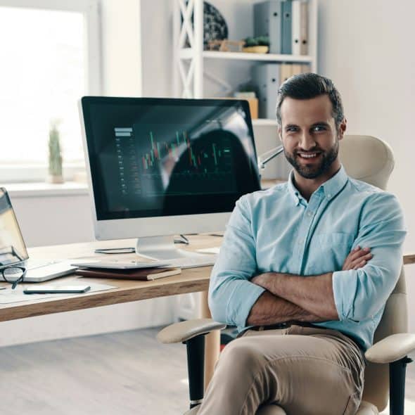 A man in the office smiling at the camera.