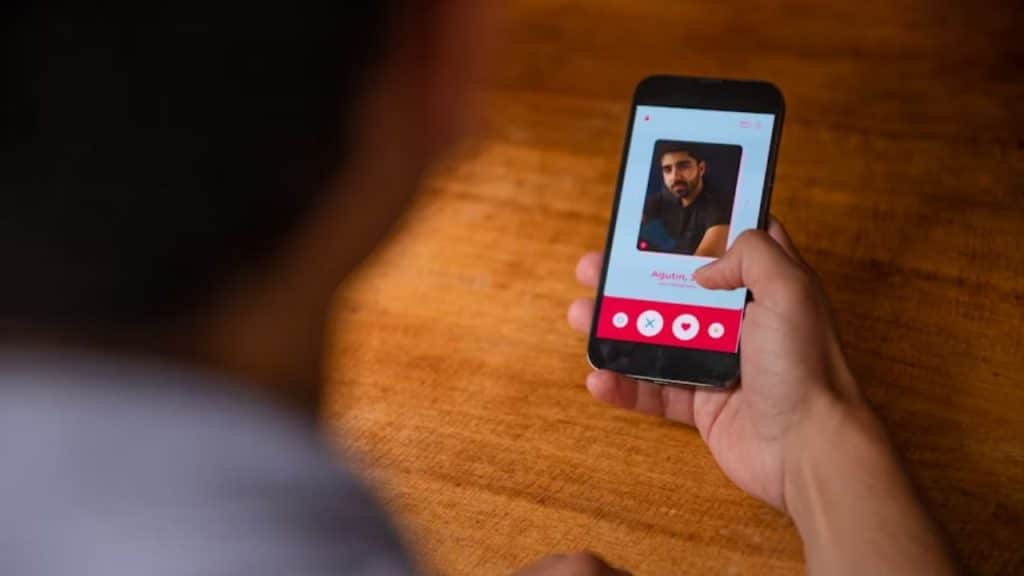 Dating app profile on smartphone with professional headshot and casual bio.