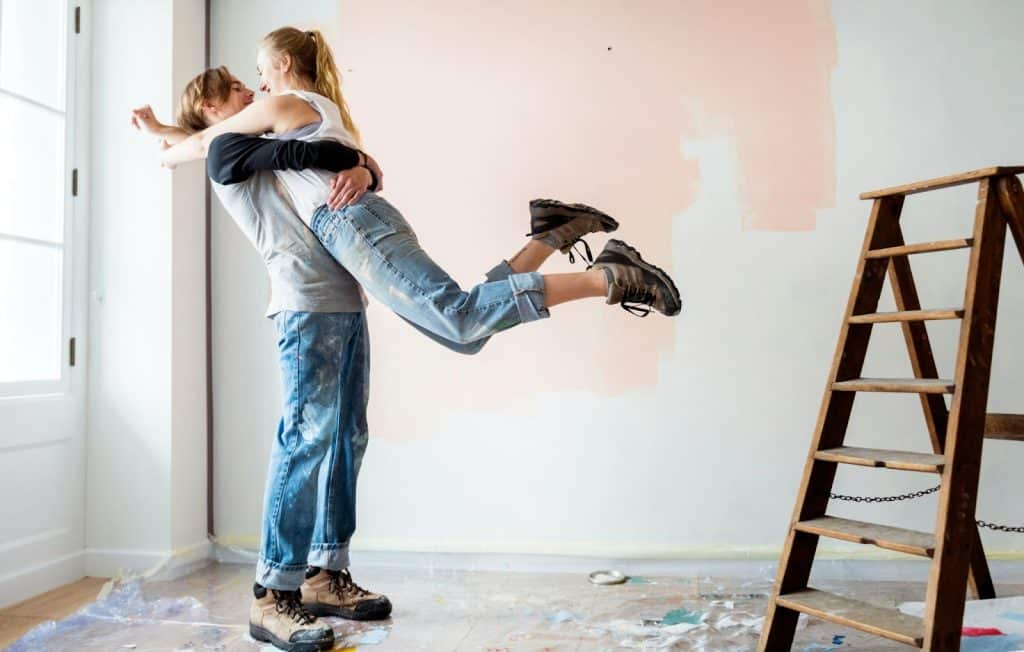 A man lifting a woman.