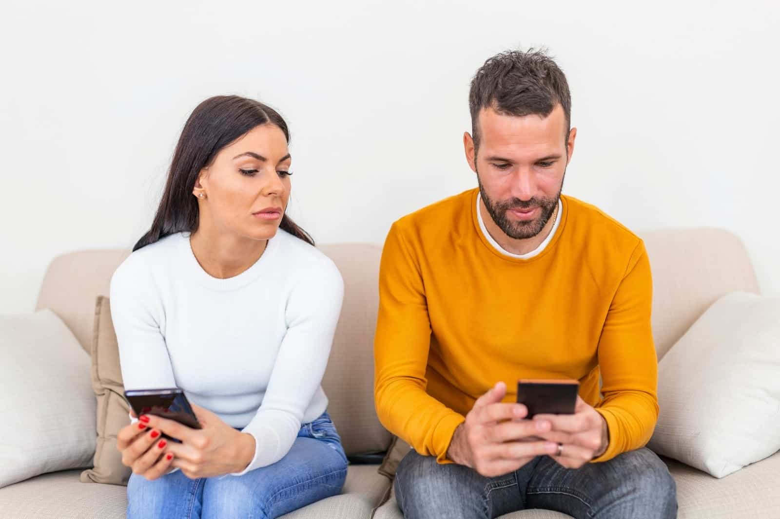 A woman looking at man’s phone.