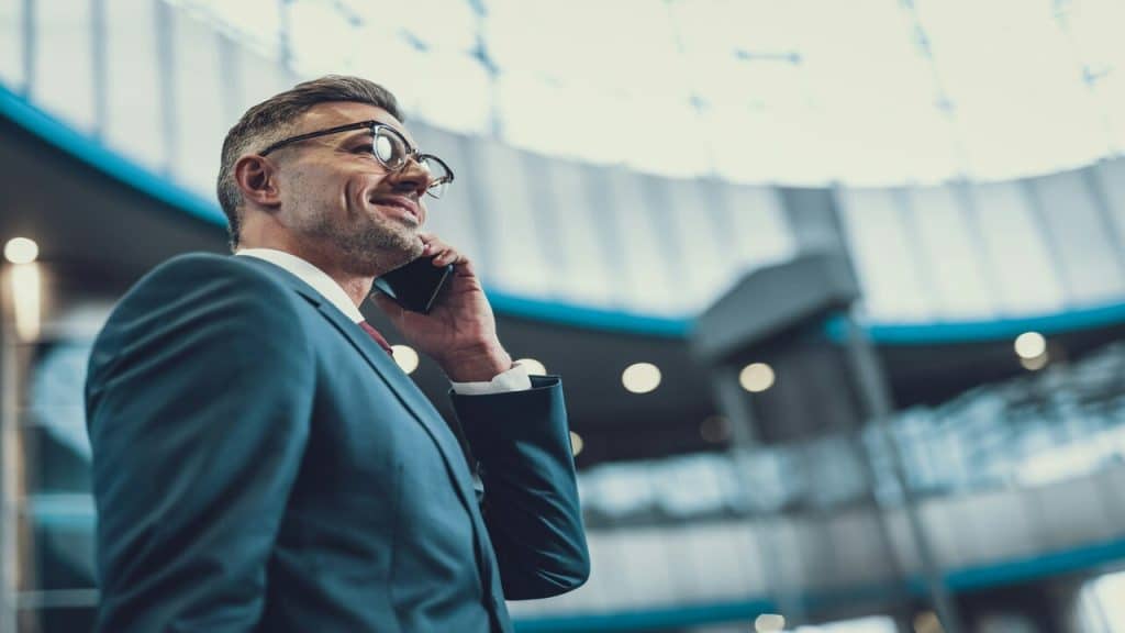 A man in a suit while on the phone