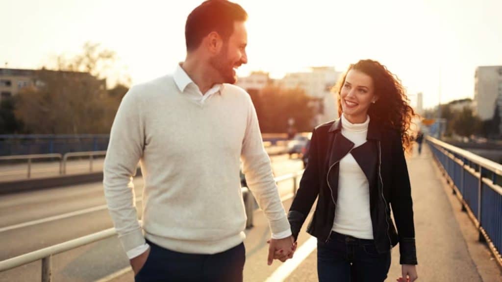 Couple walking side by side having a grounded and engaging conversation