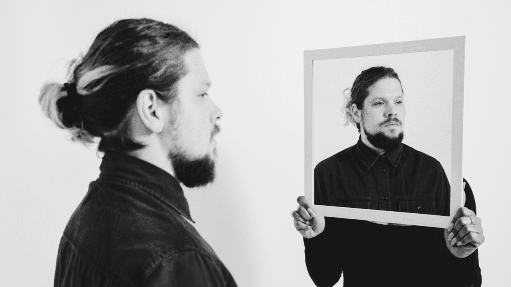 A man looking at a picture of himself