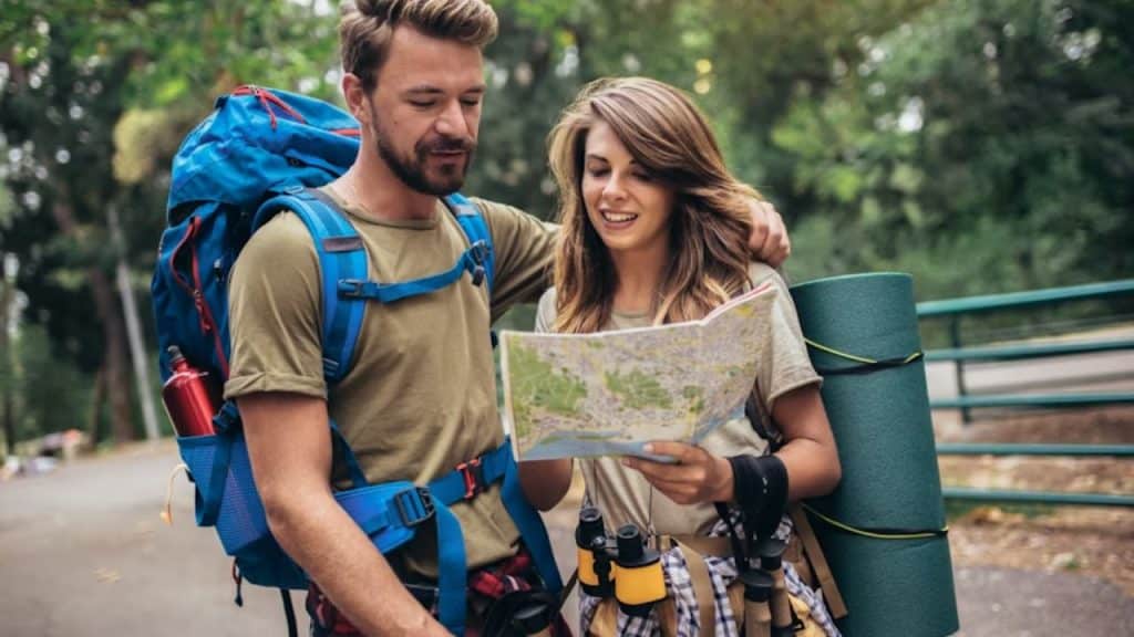 Couple comparing travel ideas with different preferences showing on a map