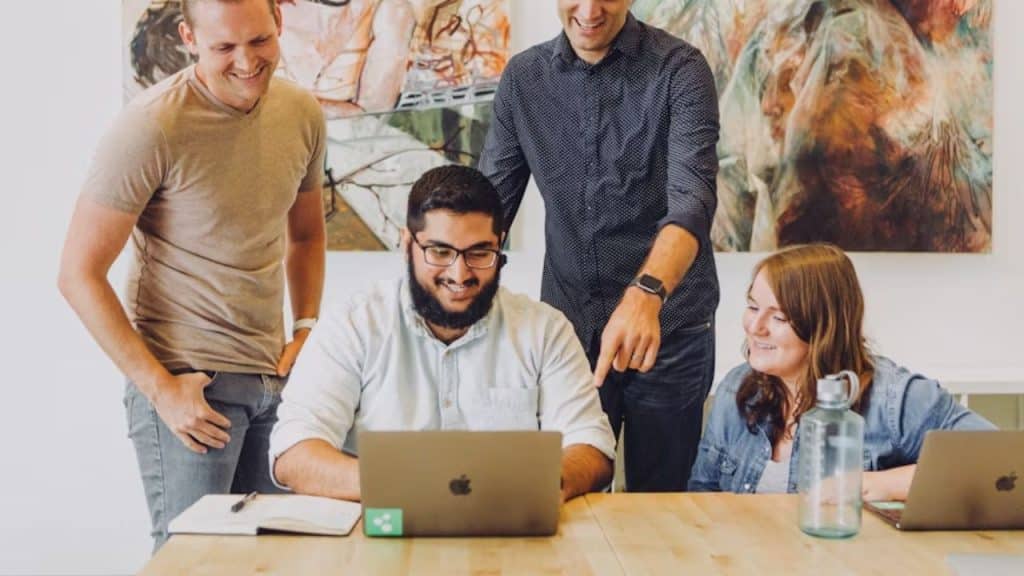 Professional man collaborating with a junior staff members in an open workspace