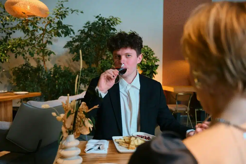 A man sipping a wine