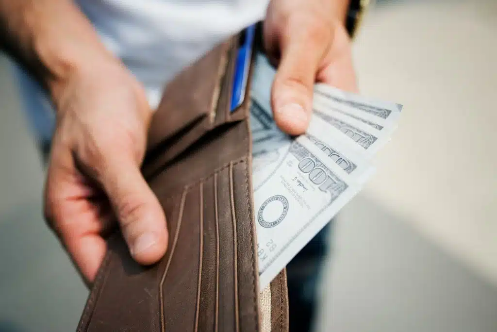 A man checking his cash in wallet.