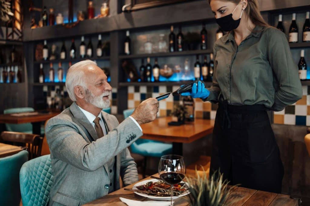 A man paying at the restaurant.