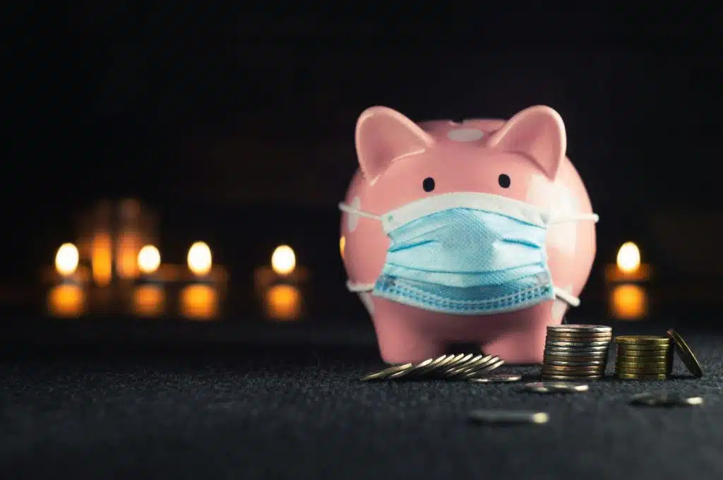 A picture of a piggy bank with a mask on it.