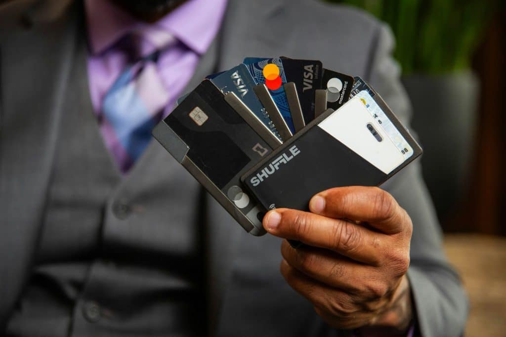 A picture of a man holding a card holder.