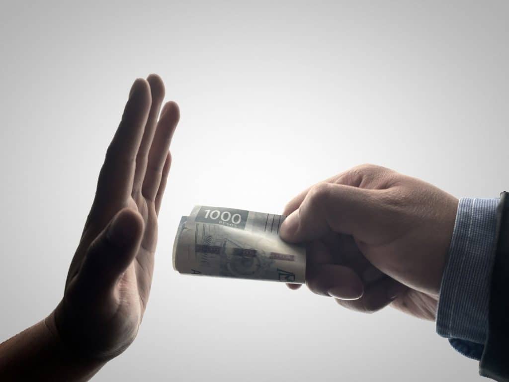 A man refusing to accept a money.