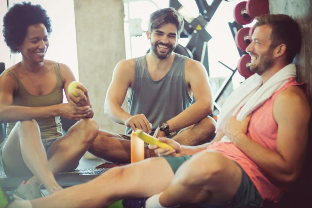 A picture of three person having a discussion.