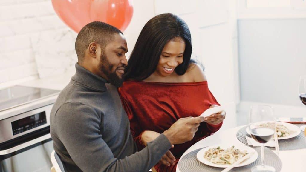 Couple playfully handing over the anniversary planning for next year.