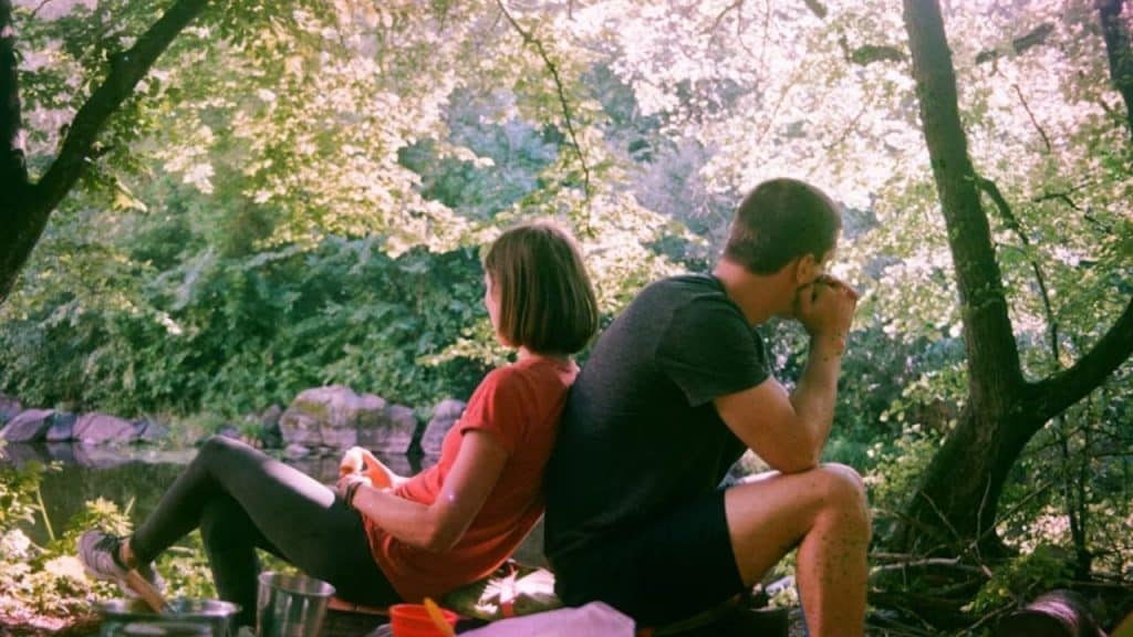 Couple taking a break from a tense moment by sitting apart to gather their thoughts.