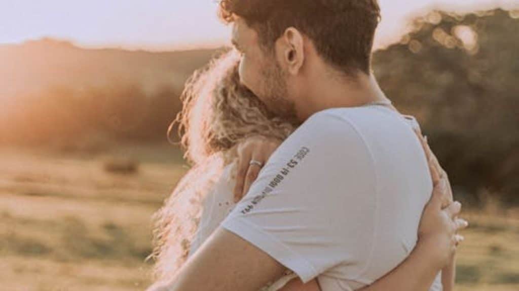 Couple embracing with mutual understanding after an honest conversation.