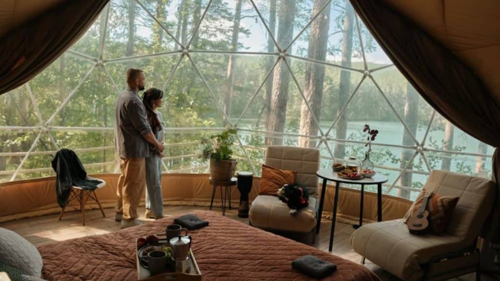 Couple enjoying a quiet weekend retreat in a cabin with forest in the background.