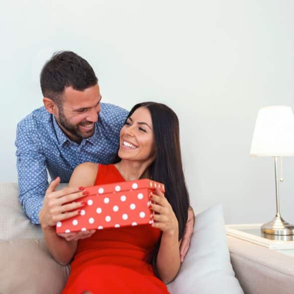 A man giving a gift to her girlfriend