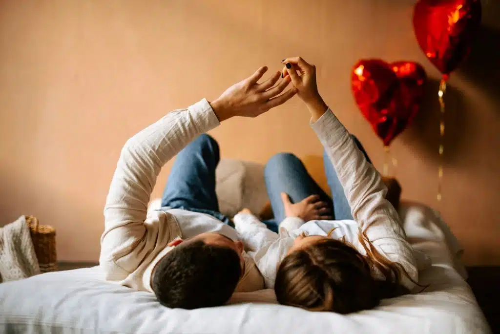 A man and woman laying on a bed
