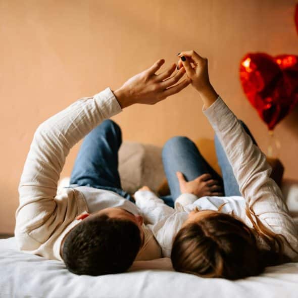 A man and woman laying on a bed