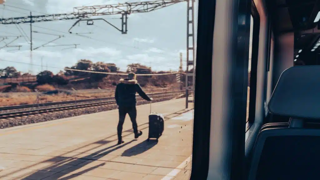 A man with a suitcase on a train platform