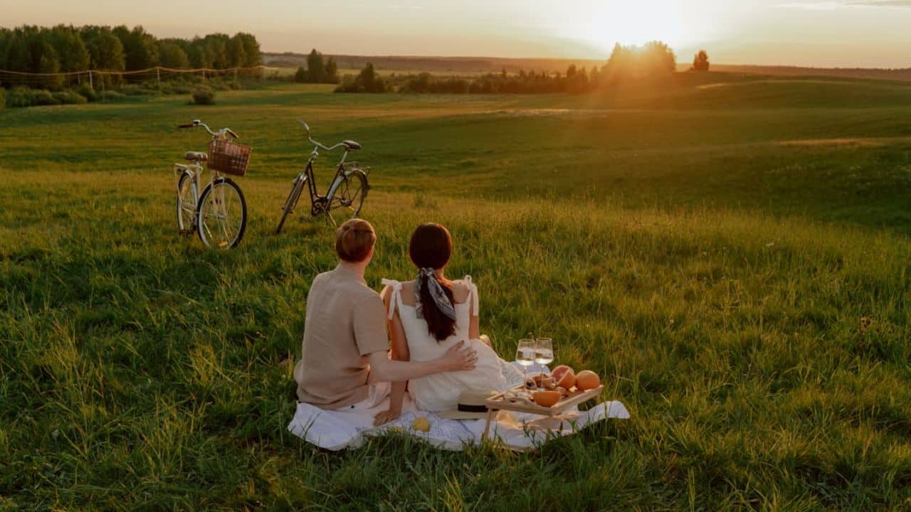 Couple sitting peacefully together at sunset without speaking.