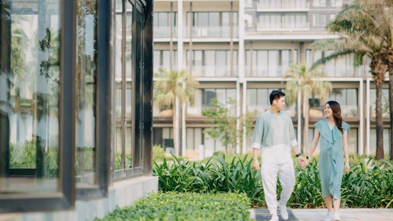 Man holding his partner’s hand gently during a relaxed walk.