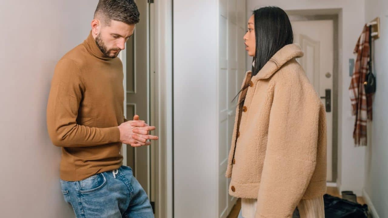 Man quietly reflecting on discrepancies in past conversations with his partner.