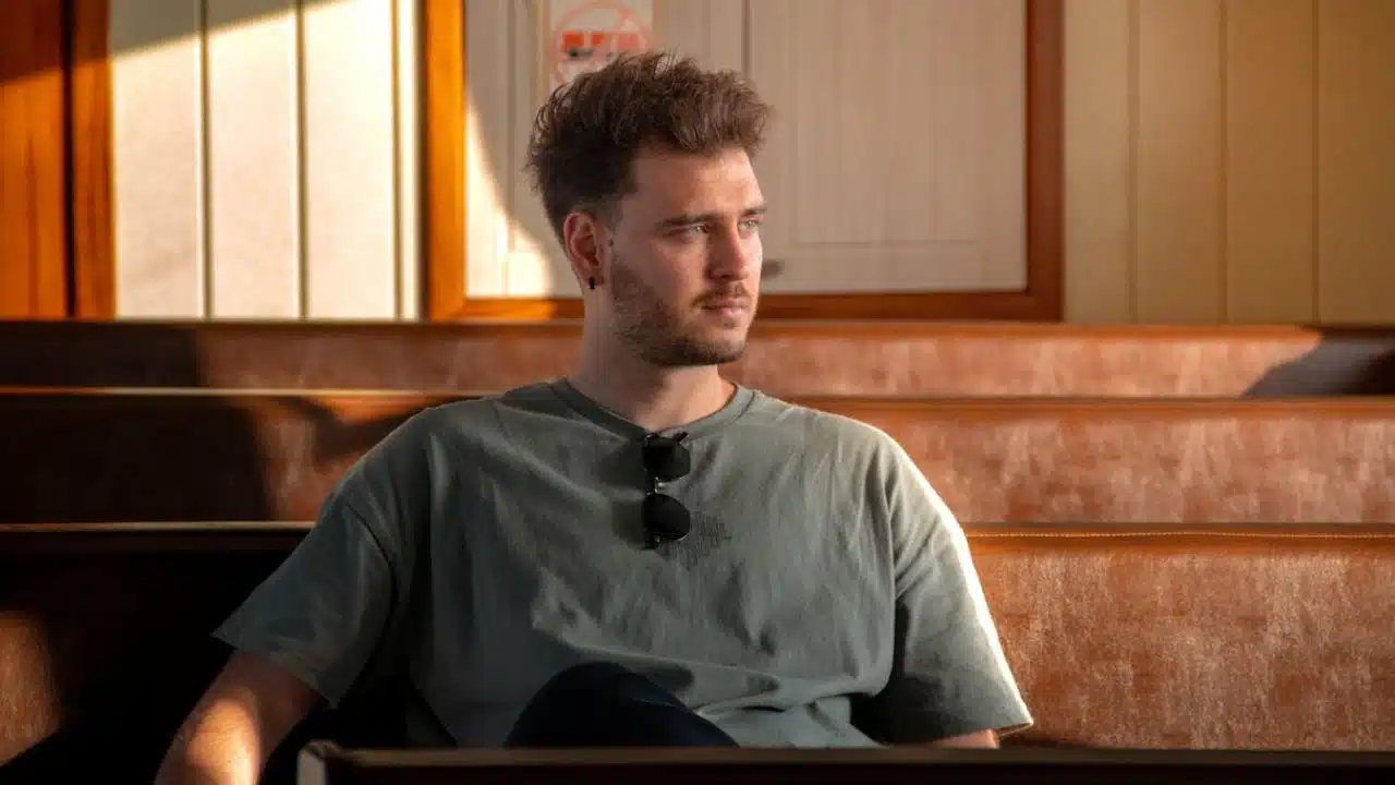 Man sitting quietly in thought, reflecting on recent interactions.