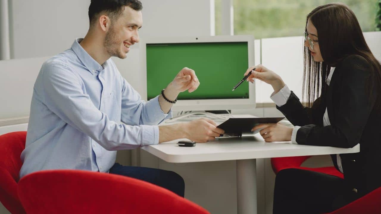 Man nodding attentively as his partner speaks, no devices in sight.