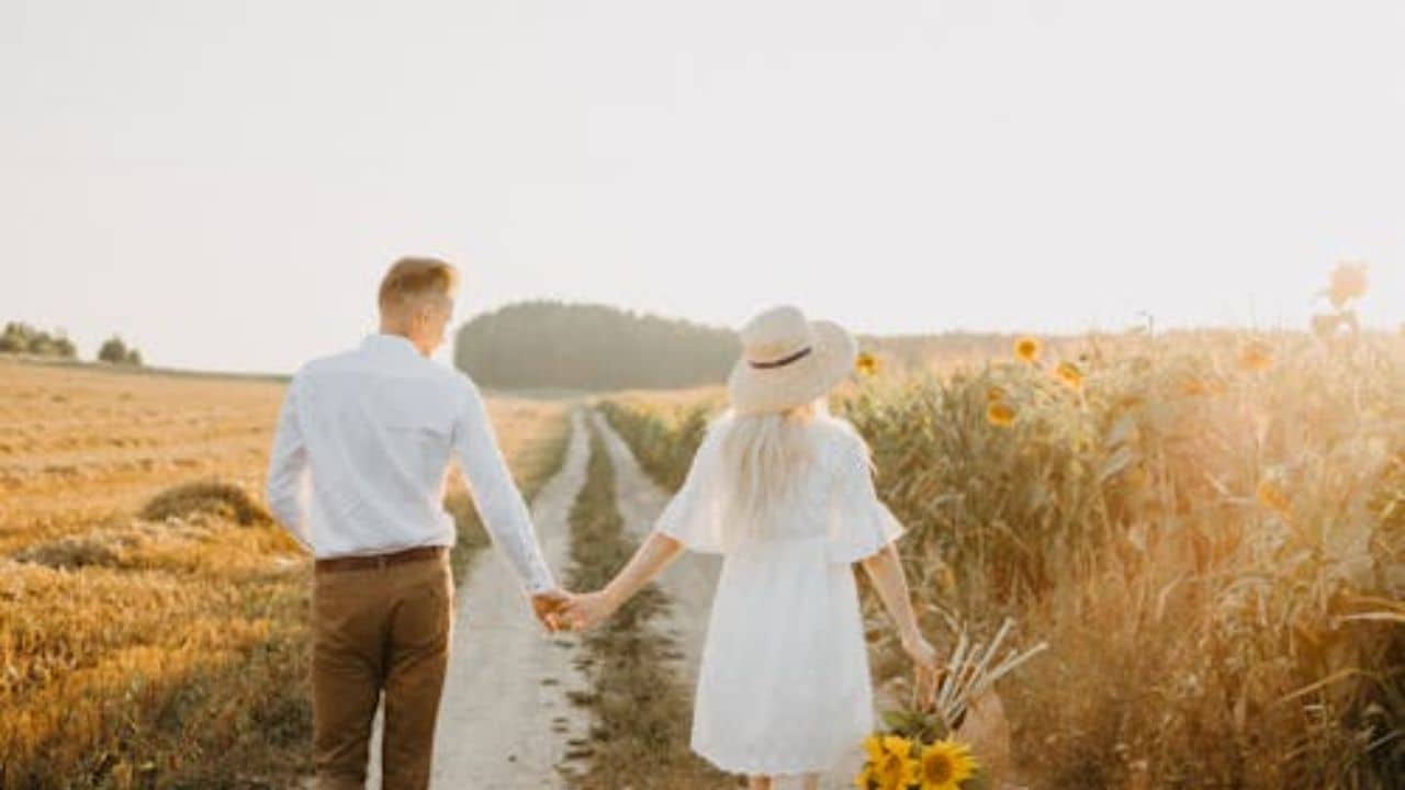 Couple walking and holding hands enjoying the beauty of nature.