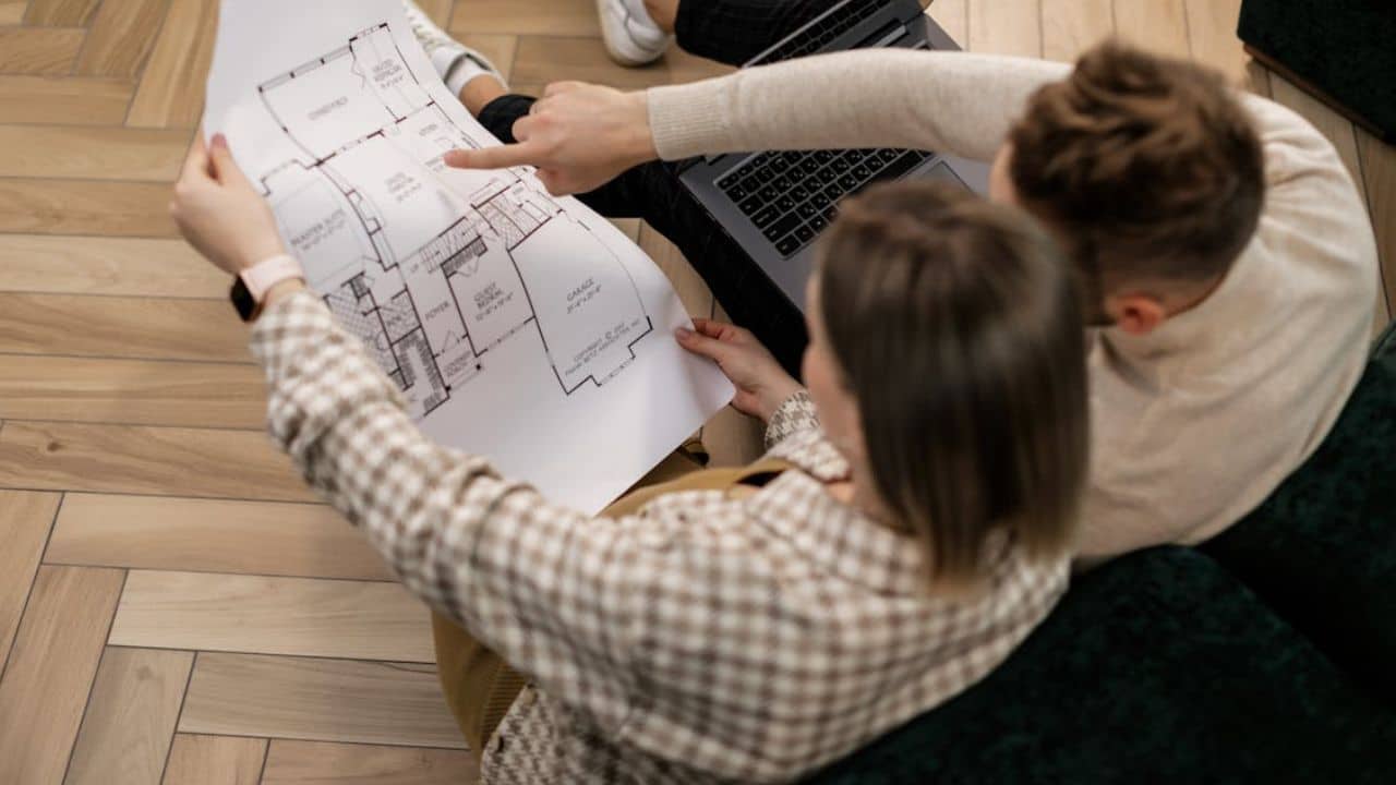 Man and woman planning the design of their own house together.