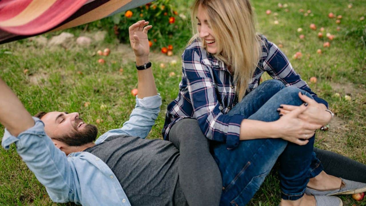 Couple talking in the park  while sharing thoughts and laughs.