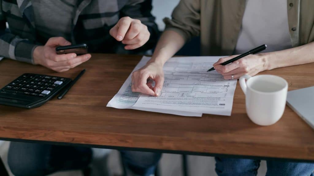 Two people looking at their bills.