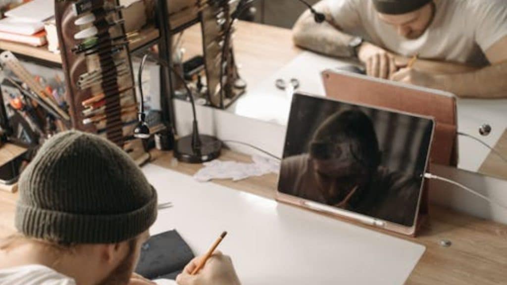 Man working out or journaling with a focused, self motivated expression.