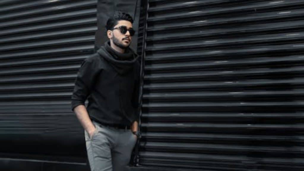 Man walking confidently down a city sidewalk with calm and purpose.